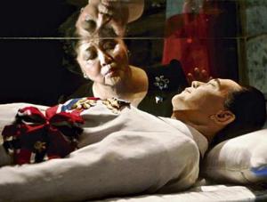 Former First Lady of the Philippines Imelda Marcos kisses the crystal coffin of her deceased husband, former President Ferdinand Marcos 